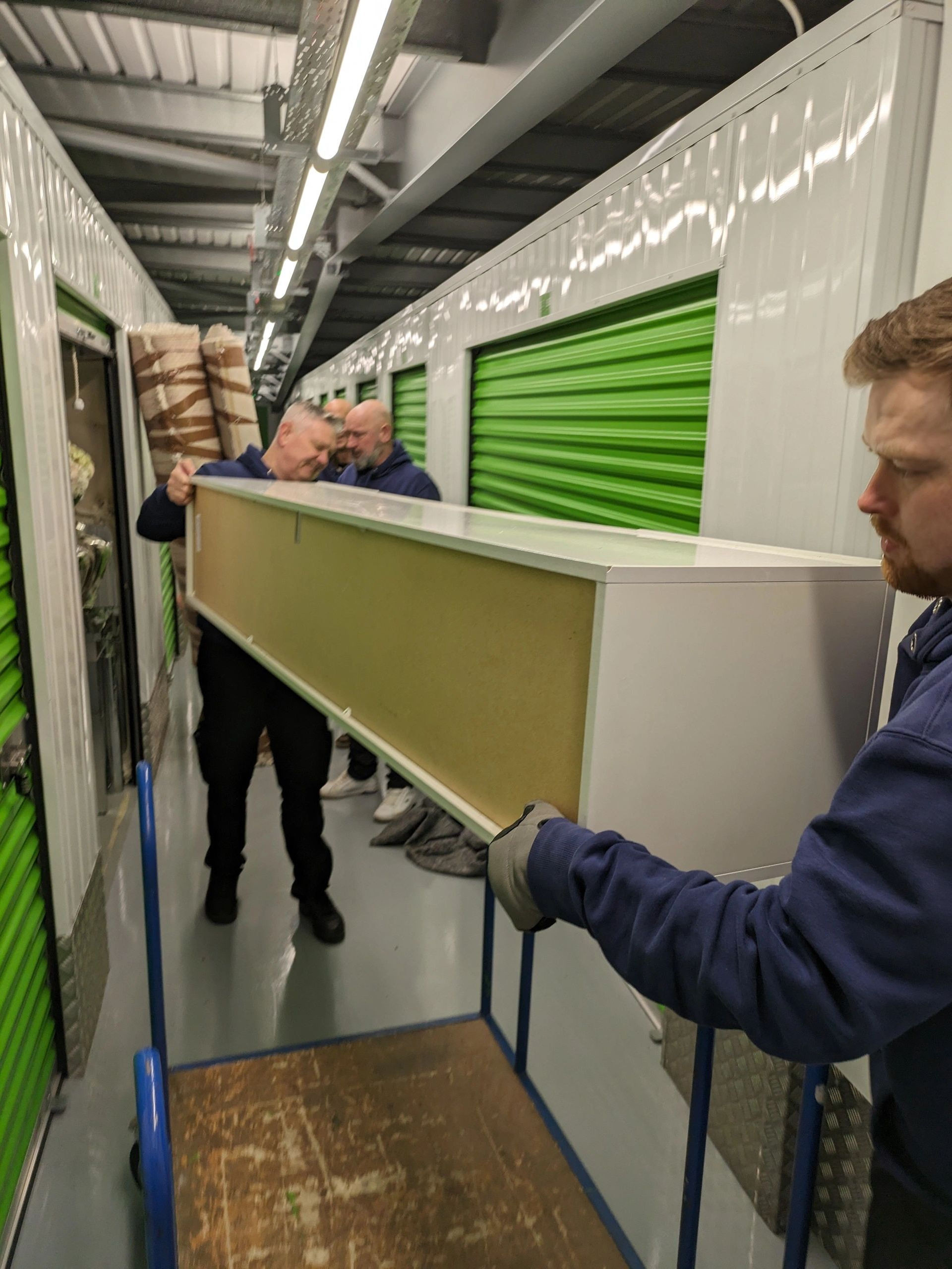 Moving men moving items into secure storage